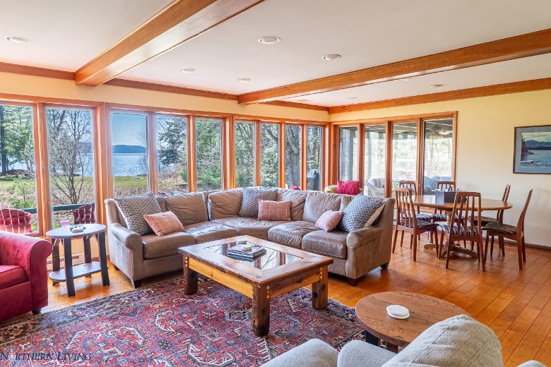 a spacious living room with furniture and tables