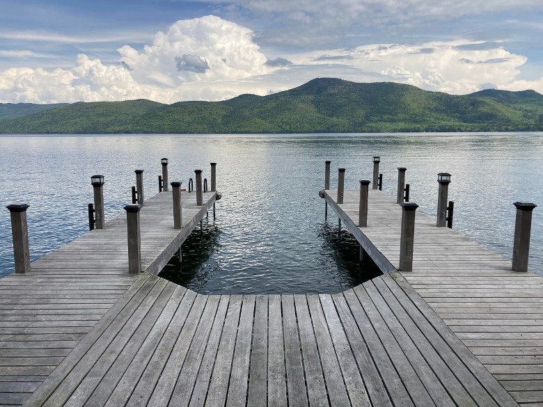 two decks extending out onto a lake