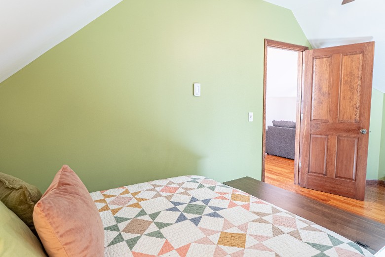 a cozy queen room with a full bath located just steps away, ensuring convenience and privacy.