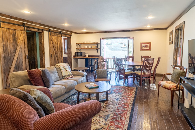 Second floor of the Carriage house living/dining area with a sofa bed, kitchenette.