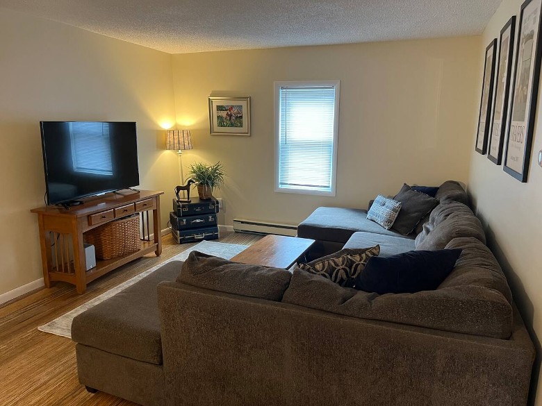 a living room space with a large couch and TV