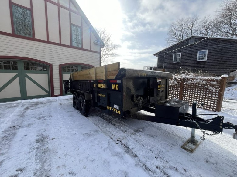 large dumpster trailer outside house