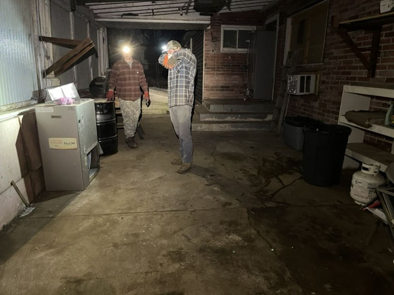 two men with headlamps in a house