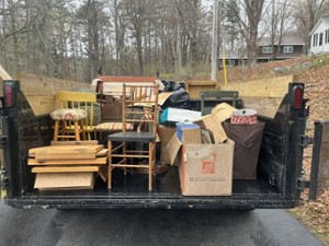 a dumpster filled with residential objects