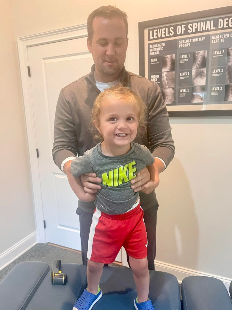 a chiropractor checking a child's stance