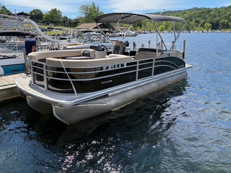 a pontoon boat docked on a lake