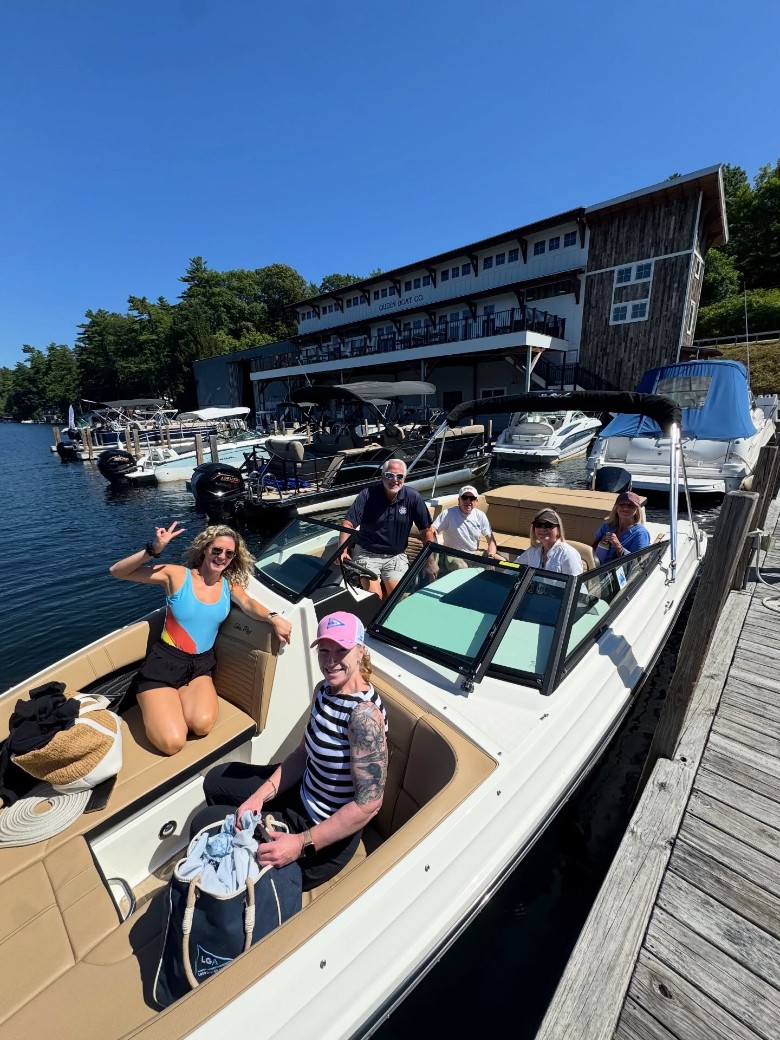 a group of people in a boat at a dock