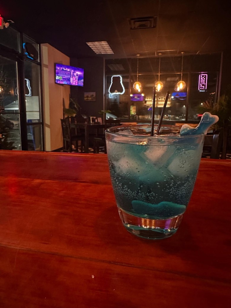 a blue cocktail on a counter