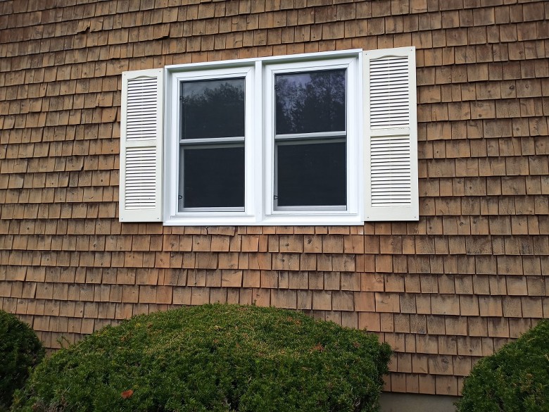 dual windows in a brown house
