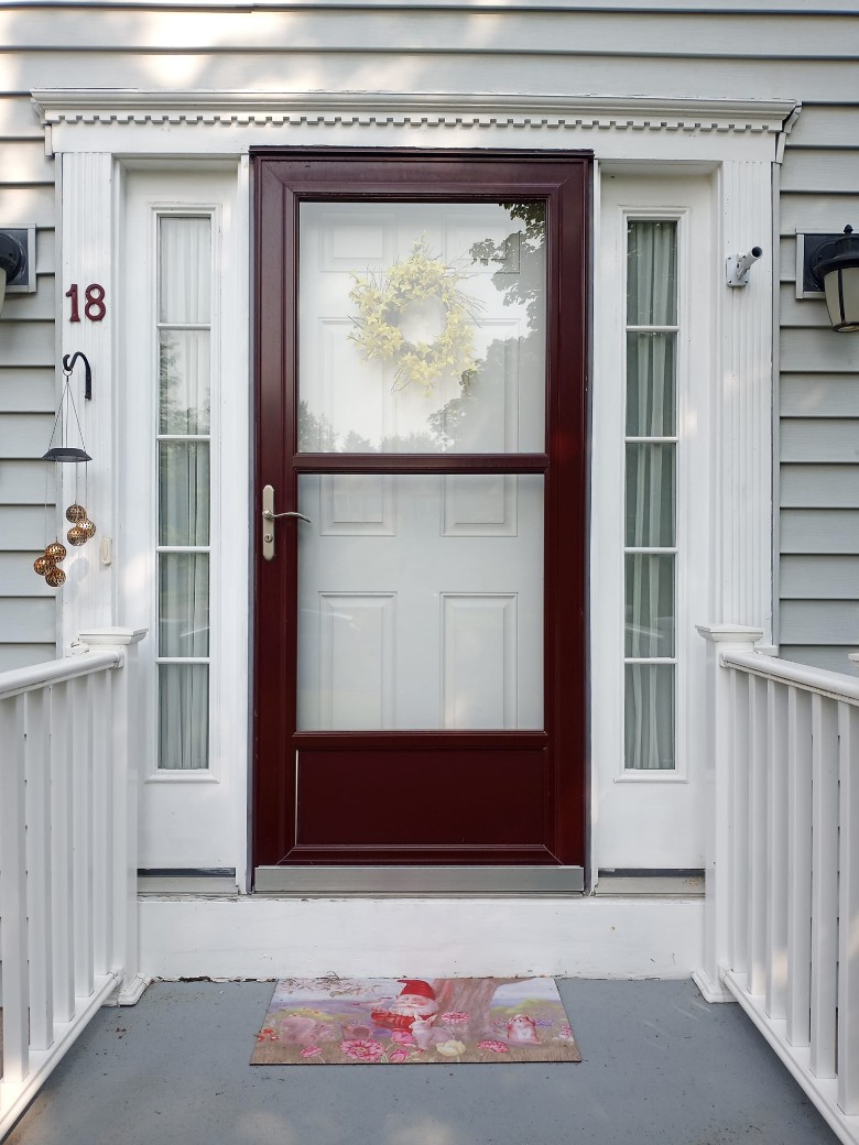 dark red door in a house with white exterior
