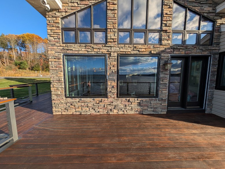 large windows in a house with stone exterior
