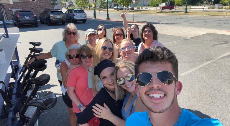 group selfie next to tour bike