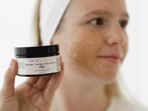 woman holds up skincare product