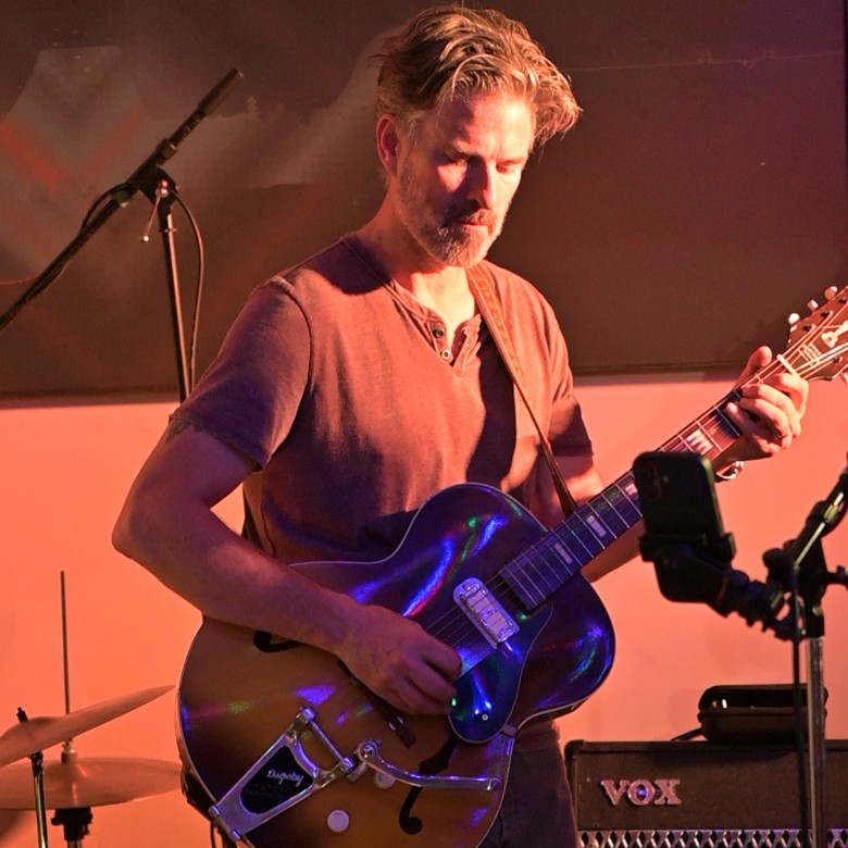 a man playing the guitar