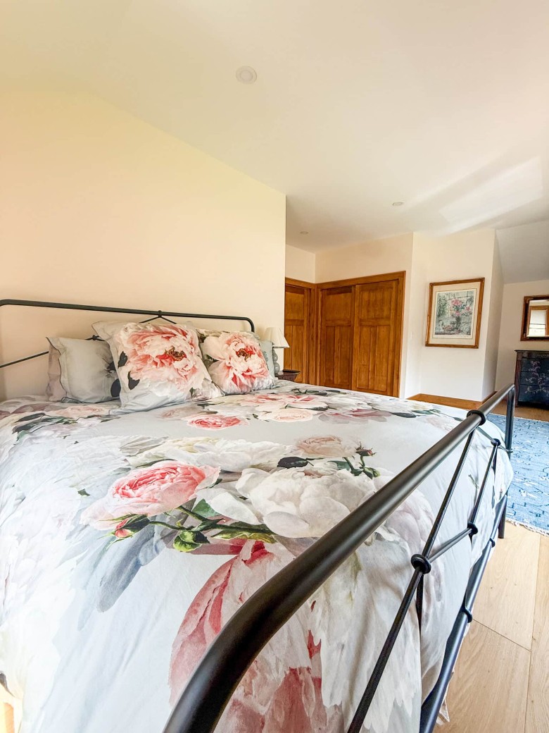 bedroom with a bed that has floral covers