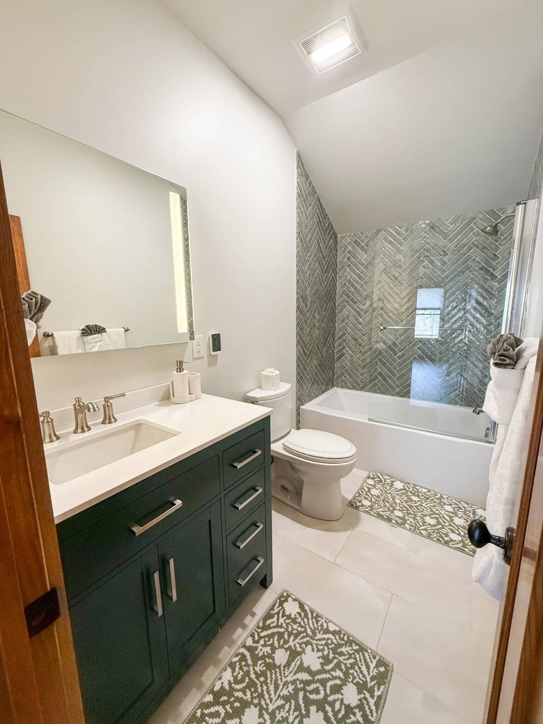 a bathroom with a tub, toilet, and sink