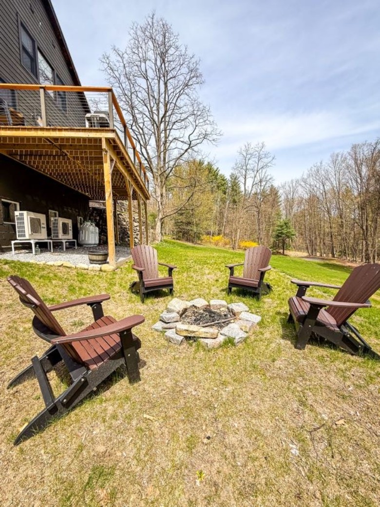 an outdoor fire pit and chairs