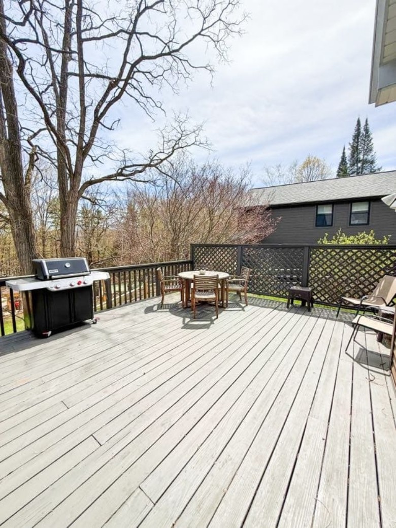 a patio with chairs and a grill