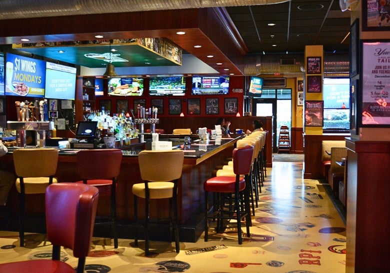 red and white chairs around a sports bar