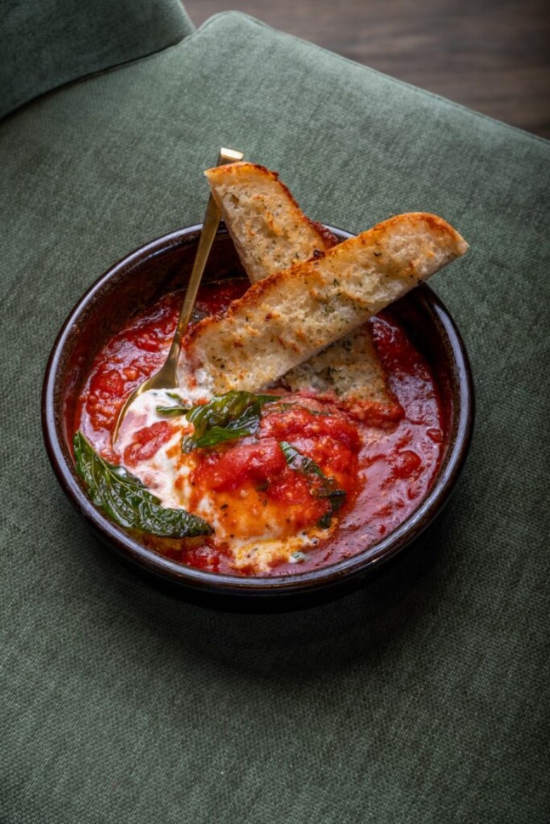 garlic bread in a bowl with red sauce