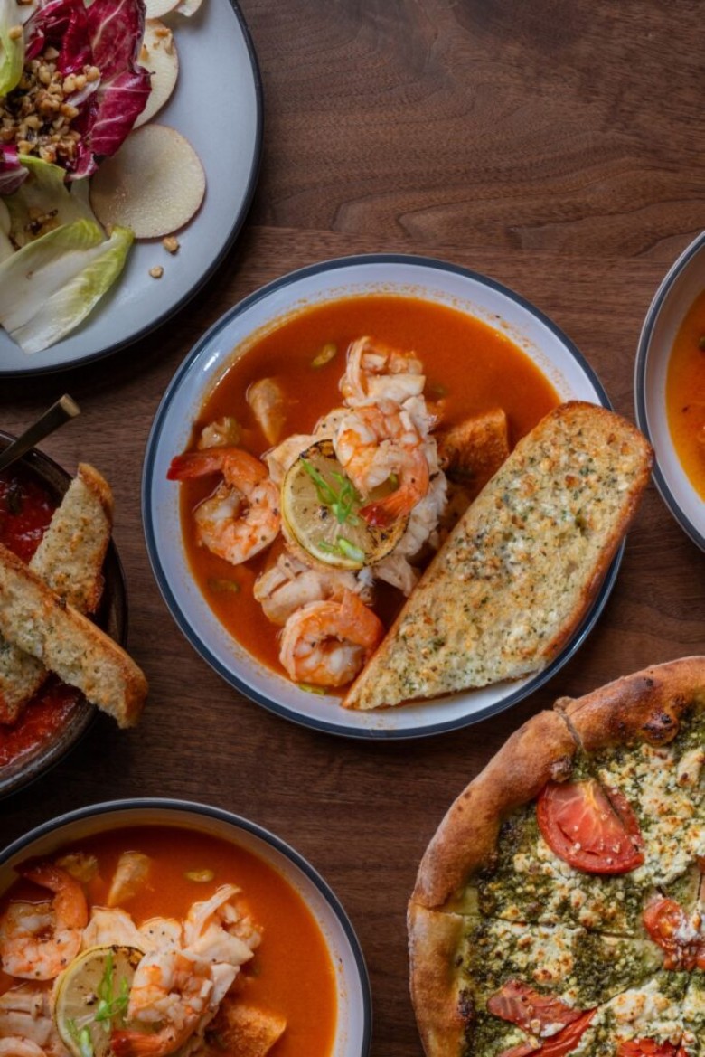 shrimp in a red soup with bread