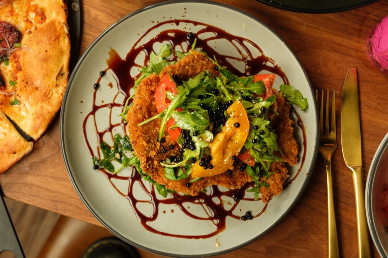 a dinner entree with greens on top
