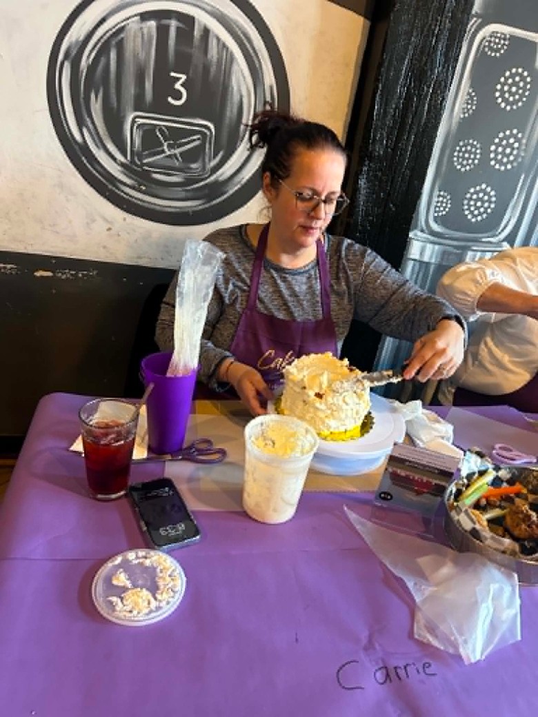 a woman decorated a buttercream cake