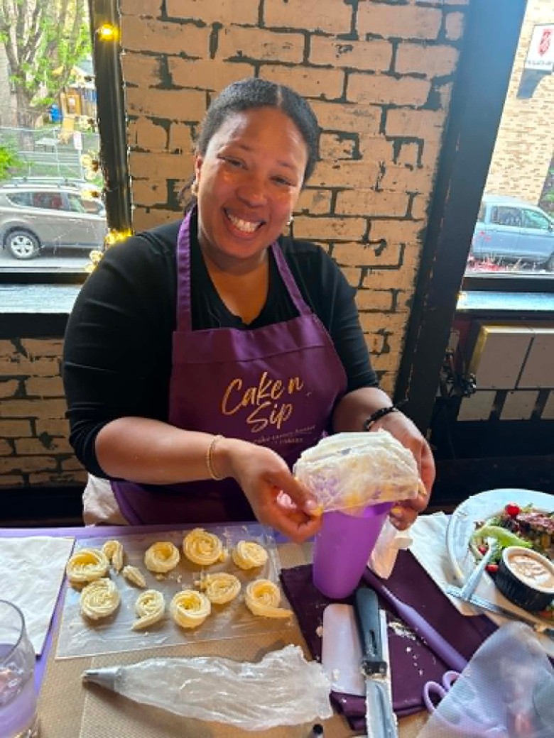 a woman seated at a cake station