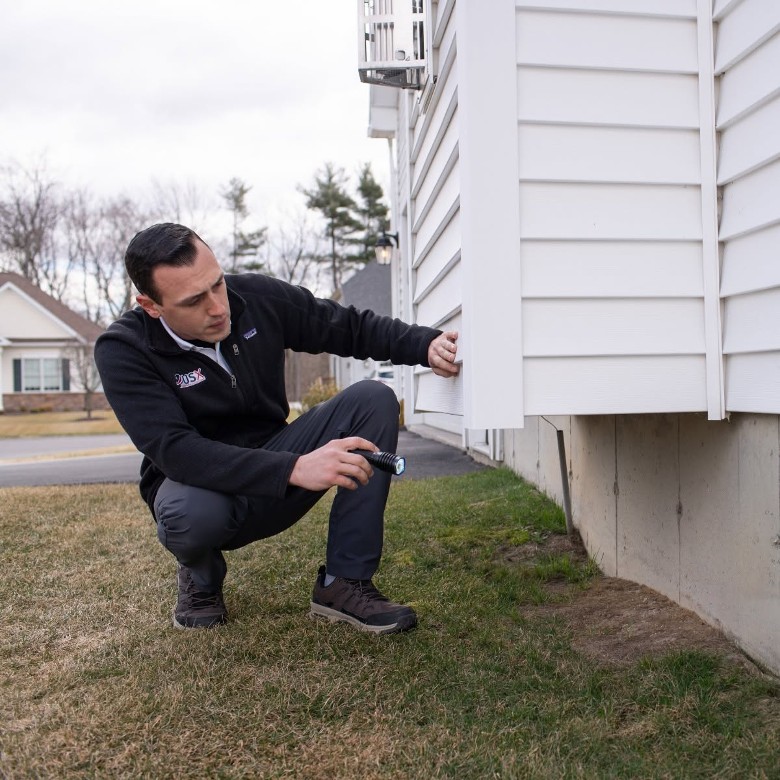 technician examining house