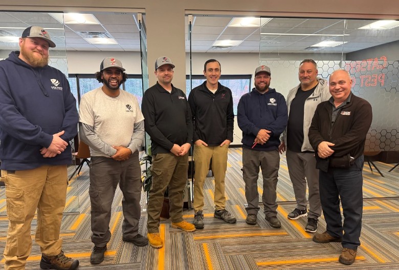 pest control team poses in office