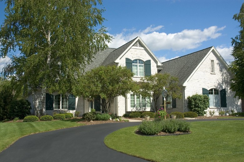 a white house with a newly paved driveway