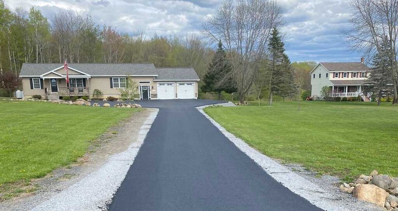 a house with a long paved driveway