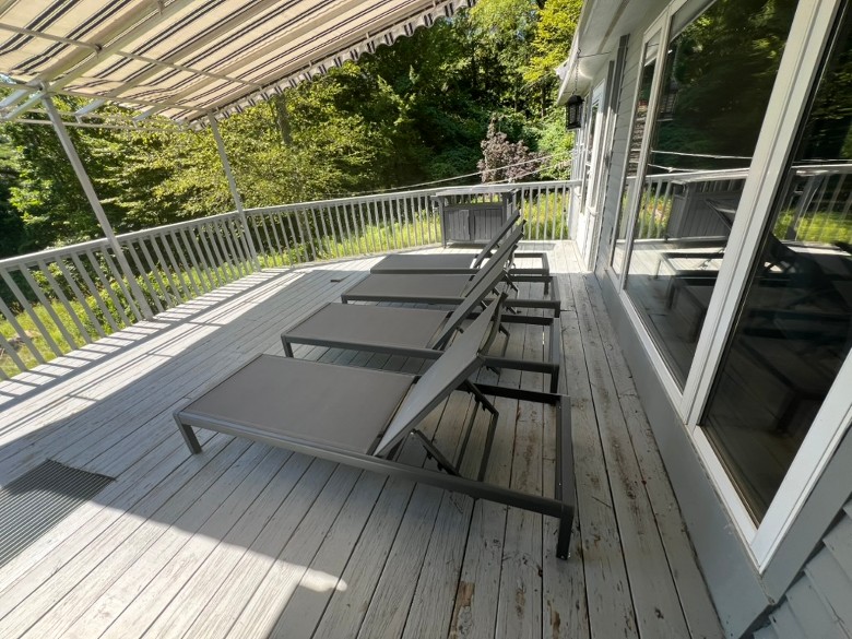 a covered house deck with lounge seating
