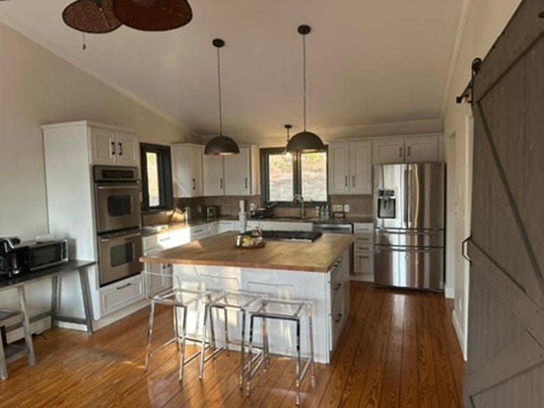 an open space kitchen with a central island