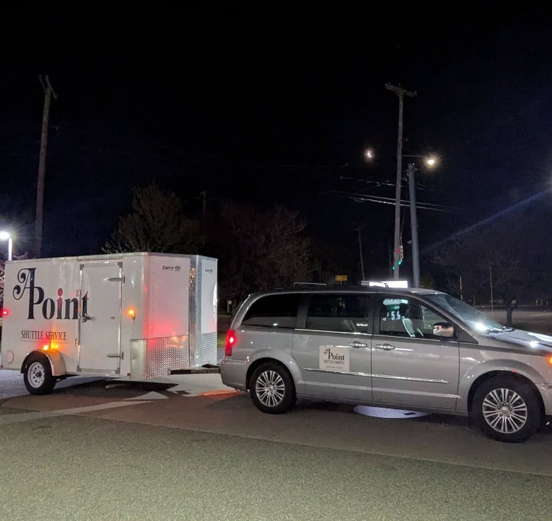 APoint Shuttle car and trailer in street at night