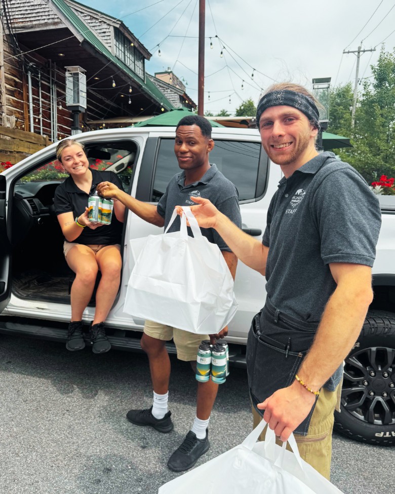 two men and one woman with catering pickup