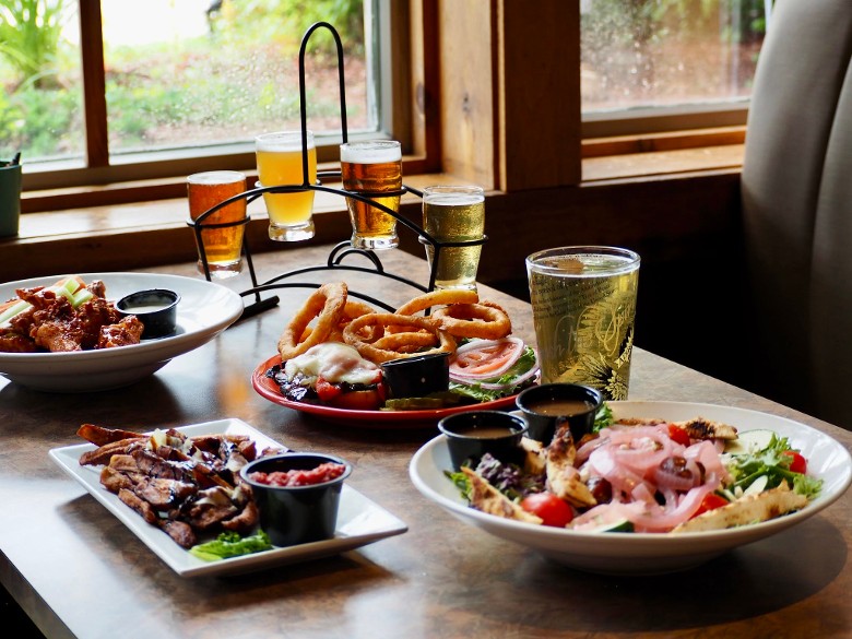 plates of food and glasses of beer on a table