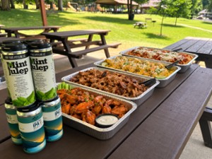 trays of food and cans of beer and cocktails