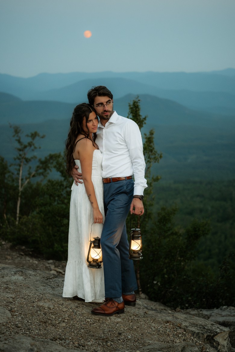 couple with lanters on mountaintop