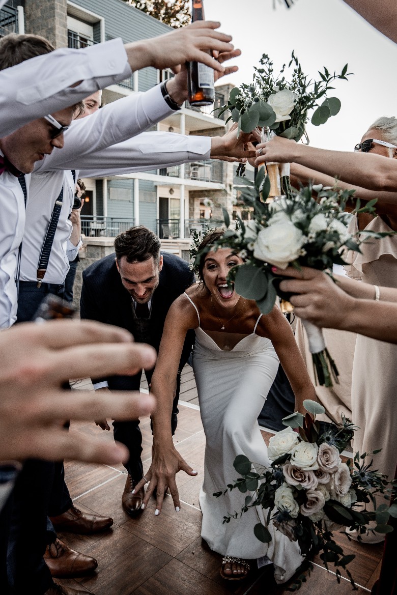 bride and groom celebrating with friends and family