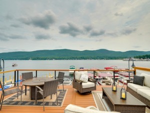 a patio deck with views of the lake and mountains