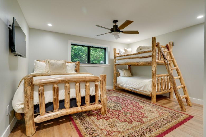 a bright bedroom with a bunk bed next to another bed