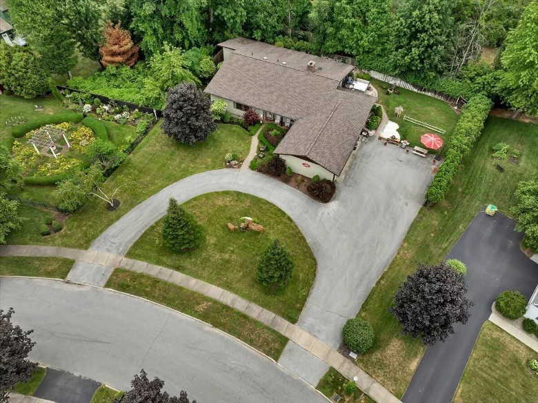aerial view of a house with a curved driveway entrance