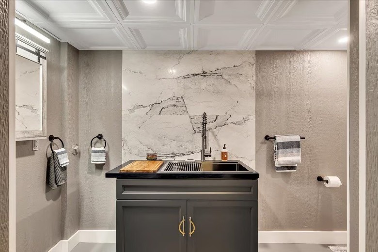 modern bathroom sink with stone wall behind it