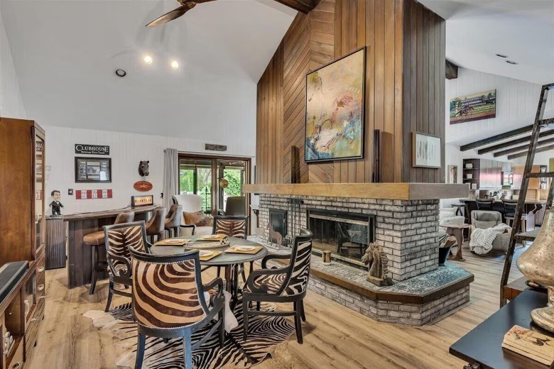 a large living room with a fireplace in the center