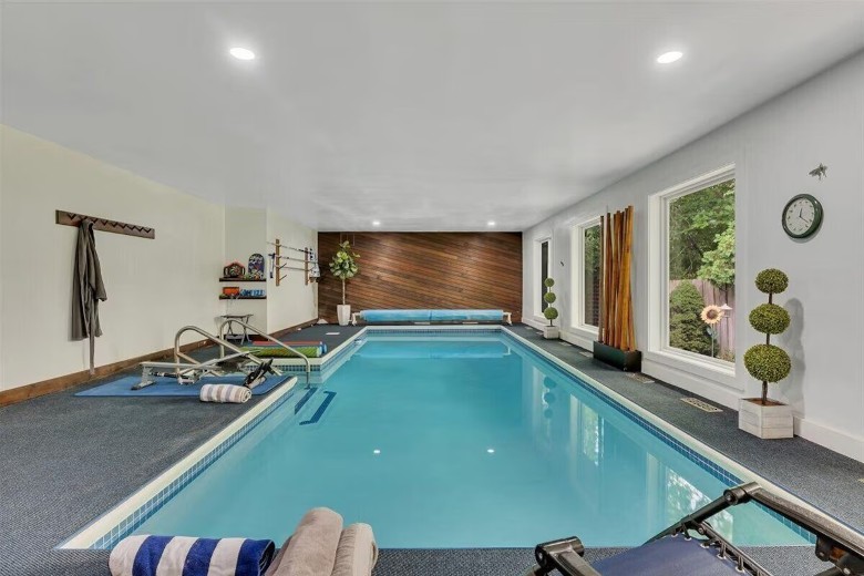 a swimming pool and windows inside of a house room