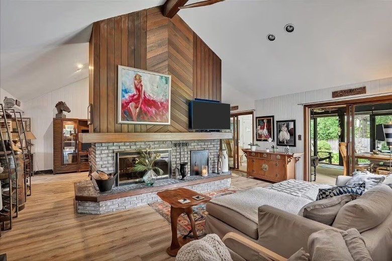 a large living room with a fireplace in the center