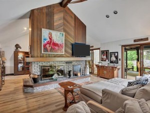 a large living room with a fireplace in the center