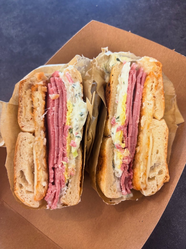 A sliced sandwich with ham and egg. sandwich split in half