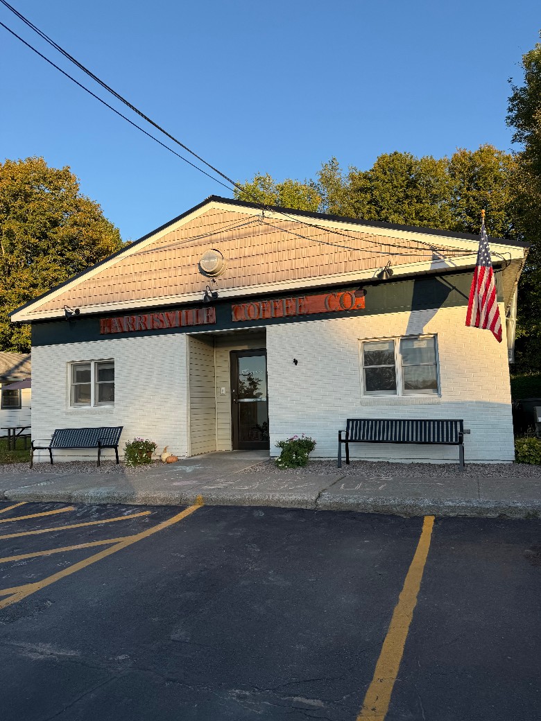 The exterior of Harrisville Coffee Co. with the American flag on display. the outside of Harrisville Coffee Co.